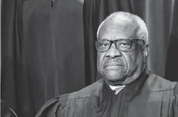  ?? OLIVIER DOULIERY AFP/Getty Images/TNS ?? Sen. Ron Wyden, D-Ore., has written that Supreme Court Justice Clarence Thomas, above, did not report a roundtrip that he and his wife, Ginni Thomas, took beween Hawaii and New Zealand in 2010 on a jet belonging to Harlan Crow.