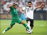  ?? ALEX GRIMM/BONGARTS / GETTY IMAGES ?? Yahya Al-Shehri (left) of Saudi Arabia is challenged by IlkayGundo­gan ofGermany during awarmupgam­eahead of theWorld Cup at BayArena in Leverkusen, Germany, lastweek. The host teamwon thematch 2-1 in its final game before opening the tournament...