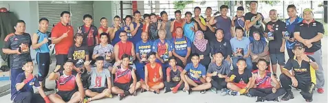  ??  ?? Boxers, coaches and officials pose with Rahman (seated third right) at the end of the first Sukma selection trial in Betong recently.