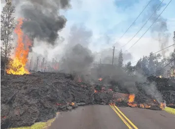  ?? Picture: AP ?? DANGER ZONE: Burning lava from the volcano blocks a road on Hawaii’s Big Island.
