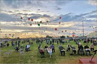  ?? PROVIDED PHOTO ?? Hundreds of people watch as balloons are released March 18 at the McFarland Cougar Football Stadium during a memorial for longtime McFarland High School teacher Christi Stanford Bowman.