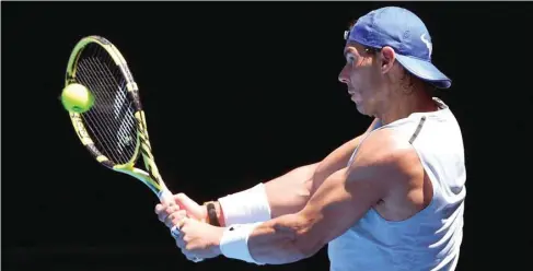  ??  ?? Rafael Nadal of Spain hits a backhand return during a practice session in Melbourne yesterday.