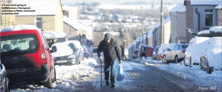  ??  ?? > It was hard going in Griffithst­own, Pontypool, yesterday as Wales continued to feel the chill