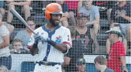  ?? JONATHON GRUENKE/STAFF ?? Fans watch as the Peninsula Pilots’ Kyle Battle steps up to the plate during the team’s home opener on July 3 at War Memorial Stadium.