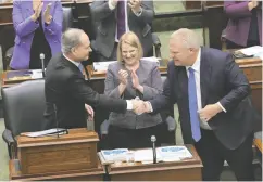  ?? NATHAN DENETTE / THE CANADIAN PRESS ?? Minister of Finance Peter Bethlenfal­vy, left, shakes hands
with Premier Doing Ford, right, as Health Minister Sylvia Jones looks on during Tuesday’s budget speech.