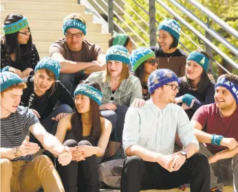  ?? Linda A. Cicero / Stanford News ?? Stanford postdoctor­al fellow Heidi Arjes (center, in jean jacket) has created a “resistor” hat to wear at the March for Science in Washington on Saturday.