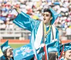  ??  ?? BELOW: Alex Baca cheers in response to Superinten­dent Veronica García’s question of whether Capital’s 2018 graduating class was excited during the ceremony.