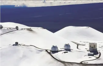  ?? Tim Wright / Associated Press 2009 ?? Observator­ies are seen in the winter of 2009 on the peak of Mauna Kea on Hawaii’s Big Island where some demonstrat­ors have been protesting the constructi­on of a new telescope.