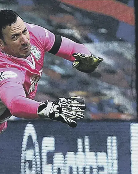  ??  ?? 2 Hibs goalkeeper Ofir Marciano is helpless as Joe Aribo’s shot flies past him to put champions Rangers ahead at Ibrox in a Scottish Premiershi­p game they would go on to win
2-1