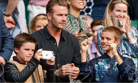  ??  ?? Looking good: David with his sons Cruz (left) and Romeo watching Andy Murray play at Wimbledon. — Reuters