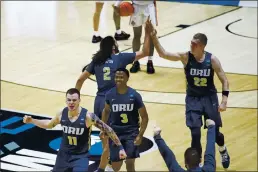  ?? ROBERT FRANKLIN — THE ASSOCIATED PRESS ?? Oral Roberts players celebrate after beating Ohio State in a first-round game in the NCAA men’s college basketball tournament, Friday in West Lafayette, Ind.