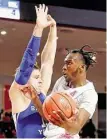  ?? Michael Wyke / Contributo­r ?? UH guard DeJon Jarreau goes up for a shot around BYU’s Taylor Maughan on Friday.