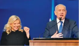  ?? — AFP ?? Israeli PM Benjamin Netanyahu addresses supporters as his wife Sara stands by at the Likud party campaign headquarte­rs in Tel Aviv on Tuesday.