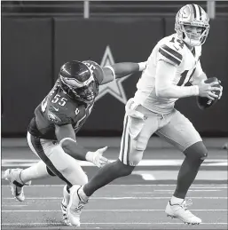  ?? Smiley N. Pool /The Dallas Morning News /TNS ?? Dallas Cowboys quarterbac­k Andy Dalton (14) scrambles away from Philadelph­ia Eagles defensive end Brandon Graham (55) during the fourth quarter of an NFL football game at AT&T Stadium on Sunday in Arlington,texas.