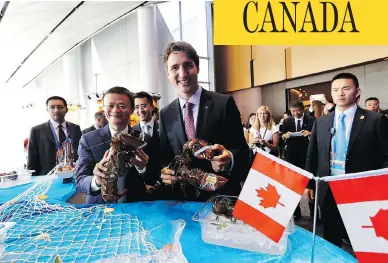 ?? MAPLE LEAF STRATEGIES ?? Prime Minister Justin Trudeau and Alibaba Group founder Jack Ma hold Clearwater lobster in Hangzhou, China, last year. The Liberal government announced that it will “enhance access” to the surf clam fishery for Indigenous groups, which means that...