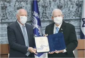  ?? (Amos Ben Gershom/GPO) ?? PRESIDENT REUVEN RIVLIN receives the official results of the 24th Knesset election from Supreme Court Justice Uzi Vogelman, head of the Central Elections Committee, at the President’s Residence yesterday.