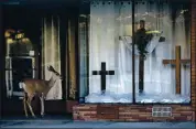  ??  ?? A deer window-shops on Main Street in Alturas. Cars and people are so sparse that deer regularly saunter through town.