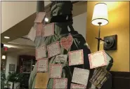  ??  ?? Notes of gratitude written by residents of the Heritage of Green Hills cover a replica of the Statue of Liberty in the community’s restaurant.