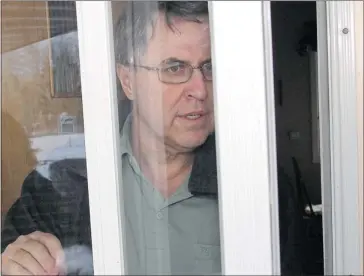  ?? Ted Rhodes/calgary Herald ?? Donald Robertshaw at the door of his southwest Calgary home, refusing to comment Tuesday on voyeurism charges.