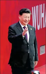  ?? WANG ZHUANGFEI / CHINA DAILY AND LI GA / XINHUA ?? President Xi Jinping (above) arrives at the opening ceremony of the 7th Military World Games on Friday in Wuhan, Hubei province. A huge dove (right) is seen formed by people at the opening ceremony.