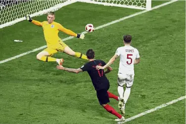  ??  ?? Save the best for last: Croatia’s Mario Mandzukic (centre) scoring his side’s second goal during the semi-final match against England on Wednesday. — AP