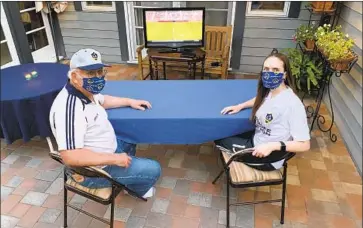  ?? CARY AND SARAH HALL, Cour tesy of Car y Hall ?? longtime Galaxy season-ticket holders, watch the team play on TV from home. Sarah says it’s “pretty hard because a lot of the fun is interactin­g with the friends we’ve made at the games.”