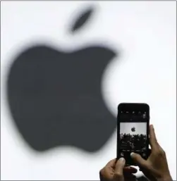  ?? ASSOCIATED PRESS FILE ?? Apple is getting ready to use iPhone cameras as an entryway into the strange world of augmented reality, taking the trend-setting company down an avenue that could usher in a new era in technology.