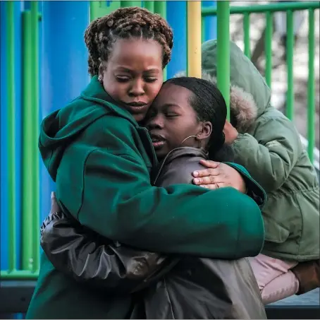  ?? AP PHOTO/BEBETO MATTHEWS ?? Derry Oliver, 17, right, hugs her mother, also Derry Oliver, during a visit to a playground near home, Friday, Feb. 9, 2024, in New York. During the COVID-19 pandemic, the younger Oliver embraced therapy as she struggled with the isolation of remote learning, even as her mother pushed back.