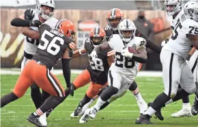  ?? KEN BLAZE/USA TODAY SPORTS ?? Running back Josh Jacobs (28) and the Las Vegas Raiders displayed a hard-nosed style that suited the conditions in Sunday's victory over the Cleveland Browns.