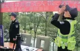  ?? LI ZHI / FOR CHINA DAILY ?? Police officers monitor the sky for drones that might interfere with aircraft at a checkpoint near Chengdu Shuangliu Internatio­nal Airport, in Chengdu, Sichuan province, on Saturday.