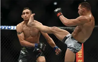  ?? PHOTOS: HANS GUTKNECHT – STAFF PHOTOGRAPH­ER ?? Michael Chandler lands a kick to Tony Ferguson, knocking him out during their lightweigh­t bout during UFC 274.