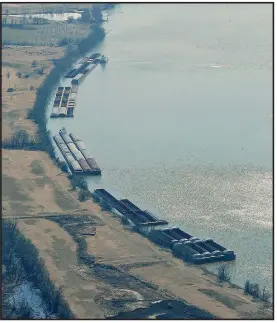  ??  ?? A line of barges wait on the east side of the drawbridge that crosses the Arkansas River between Van Buren and Fort Smith, which committed to build a port before the navigation system was completed.