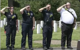  ?? ?? Saluting during the ceremony during the playing of taps were members of the Devens Fire Department. From left is firefighte­r Ammie Boucher, Jazmin Murillo, Mark Boucher and Chief Tim Kelly.