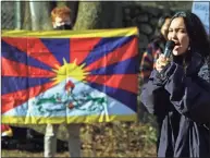  ?? Christian Abraham / Hearst Connecticu­t Media ?? Tibetan activist Tsela Zoksang leads a protest at the gate leading to NBC’s campus on Blachley Road in Stamford, on Saturday. Around 20 people gathered to protest China’s human rights violations, NBC and its involvemen­t in covering the 2022 Winter Olympics in Beijing.