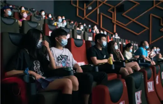  ??  ?? Film buffs watch a film in a cinema in Wuhan, Hubei Province in central China, on July 20, the day cinemas were allowed to reopen in low-risk areas