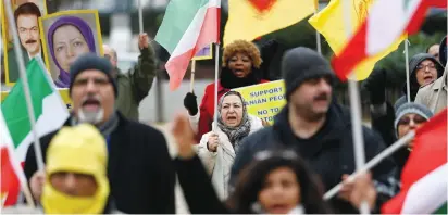  ?? (Francois Lenoir/Reuters) ?? PEOPLE CHANT slogans during a protest against the visit of Iranian Foreign Minister Mohammad Javad Zarif held outside the European Union Council in Brussels yesterday.