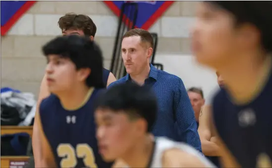  ?? REBA SALDANHA — BOSTON HERALD ?? Needham boys volleyball coach Dave Powell watches game action against Natick on April 4. Needham has won three straight state titles.