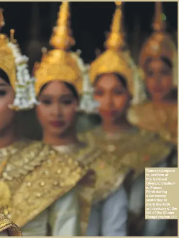  ?? AFP ?? Dancers prepare to perform at the National Olympic Stadium in Phnom Penh during a ceremony yesterday to mark the 40th anniversar­y of the fall of the Khmer Rouge regime