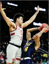  ?? AP PHOTO BY ISAAC BREKKEN ?? Stanford's Dorian Pickens, left, blocks a shot by California's Don Coleman, right, during the first half of an NCAA college basketball game in the first round of the Pac-12 men's tournament Wednesday in Las Vegas