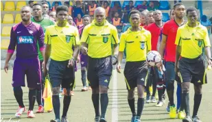  ??  ?? Nigerian referees lead two teams out of the tunnel for a league match