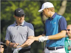  ?? TONY DEJAK — ASSOCIATED PRESS ?? Rory McIlroy, left, and Jordan Spieth finished the first round two strokes behind leader Thomas Pieters on Thursday at the WGC Bridgeston­e Invitation­al.