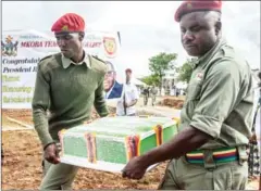  ?? JEKESAI NJIKIZANA/AFP ?? ZANU PF party members carry a 93kg ice cream cake during the 93rd birthday celebratio­ns of Zimbabwean President Robert Mugabe in Matopos, Zimbabwe, on Saturday.
