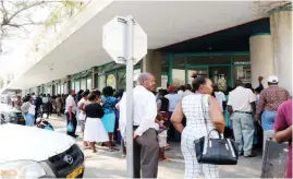  ??  ?? A long winding queue of electricit­y consumers queuing to buy electricit­y tokens along 10th Avenue in Bulawayo yesterday
