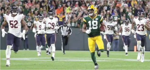  ?? GETTY IMAGES ?? Packers receiver Randall Cobb outruns Bears defenders on his way to the end zone for the go-ahead 75-yard touchdown catch. The Bears got the ball back but were unable to score.