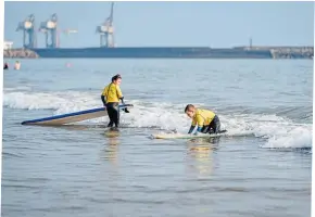  ?? ?? Surfing is a popular pastime on the coastal water at Aberavon.