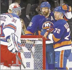  ?? GETTY ?? Anthony Beauvillie­r (r.) gets hug from Andrew Ladd after putting shot past Ranger goalie Ondrej Pavelec at Barclays Center, where Islanders beat Rangers on Thursday night.