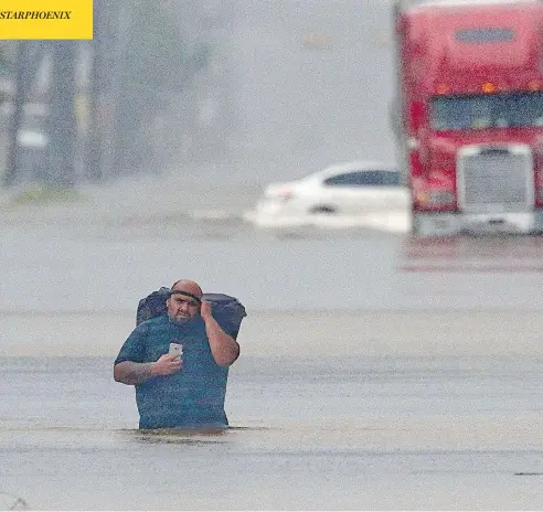  ?? THOMAS B. SHEA / AFP / GETTY IMAGES ?? A man walks through flood waters in Houston, Texas, on Sunday, as the fourth-largest U.S. city continues to be pummelled by Hurricane Harvey.