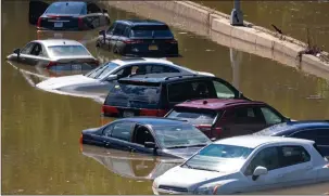  ?? The Associated Press ?? Cars are stranded by high water on the Major Deegan Expressway in Bronx borough of New York as high water left behind by Hurricane Ida still stands on the highway hours later.