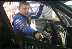  ?? GENARO C. ARMAS — THE ASSOCIATED PRESS ?? Sports car driver Michael Johnson explains how he drives his No. 54 Audi in the garage at Road America in Elkhart Lake, Wis., Thursday. Johnson, who is paralyzed from the waist down, is coming off his first profession­al win in the TCR class of the IMSA Continenta­l Tire SportsCar Challenge.