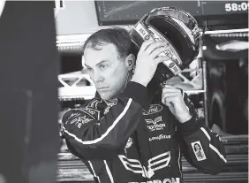  ?? ASSOCIATED PRESS PHOTOS ?? Pole winner Kevin Harvick takes his helmet off in the garage during practice Saturday for today’s NASCAR Monster Energy Cup series at Atlanta Motor Speedway in Hampton, Ga.